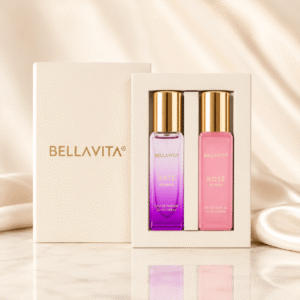 ​Bella Vita luxury perfume gift set for women featuring two 20ml Eau De Parfum bottles, Date Woman in a purple gradient bottle and Rosé Woman in a pink bottle, displayed inside an elegant cream box with gold lettering against a soft, silky background.